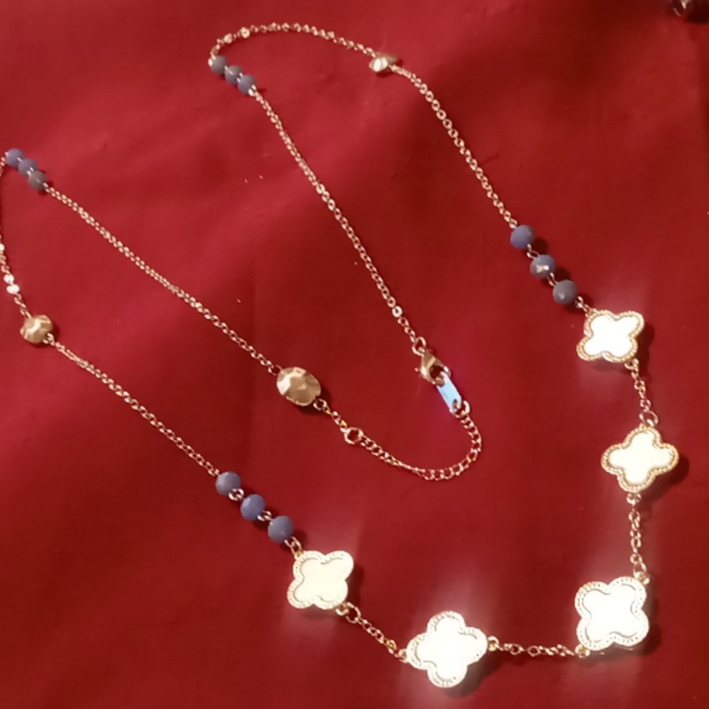 Long clover flower necklace 36 in gold tone stainless steel & blue beaded.